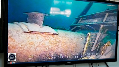 Shot from a television screen shows damage to anchor support.