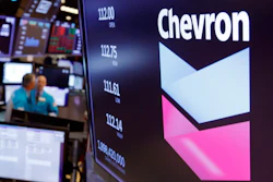 Chevron logo appears above a trading post on the floor of the New York Stock Exchange.