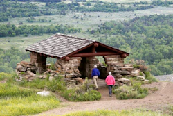 Visitors hike to a stone lookout over the Little Missouri River inside the Theodore Roosevelt National Park.