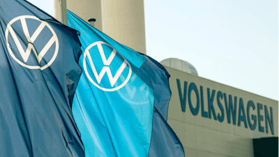 Flags wave in front of a factory building during the production restart of a VW plant in Zwickau, Germany.
