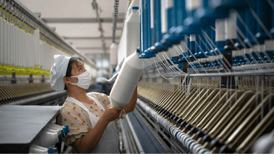 A woman works in a textile factory in Hai'an in eastern China's Jiangsu Province.