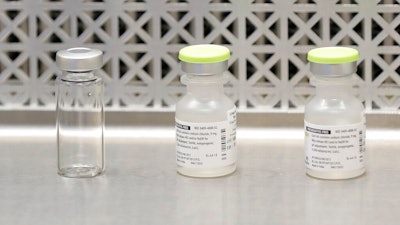 This March 16, 2020 file photo shows vials used by pharmacists to prepare syringes used on the first day of a first-stage safety study clinical trial of the potential vaccine for COVID-19, the disease caused by the new coronavirus, at the Kaiser Permanente Washington Health Research Institute in Seattle. The world's biggest COVID-19 vaccine test got underway Monday, July 27 with the first of 30,000 planned volunteers. The experimental vaccine is made by the National Institutes of Health and Moderna Inc., and it's one of several candidates in the final stretch of the global vaccine race.