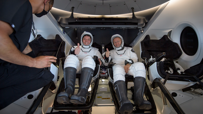 The SpaceX Crew Dragon Endeavour spacecraft is lifted onto the SpaceX GO Navigator recovery ship shortly after it landed with NASA astronauts Robert Behnken and Douglas Hurley onboard in the Gulf of Mexico.