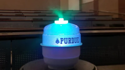 The prototype of device that uses food coloring to neutralize airborne viruses being demonstrated in a classroom.