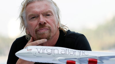 Richard Branson attends a news conference.