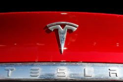 The company logo appears on an unsold 2020 Model X.