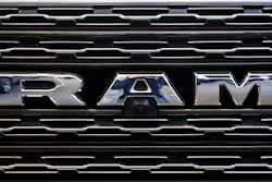 The Ram logo on the front grill of a Ram 1500.