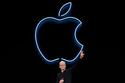 In this June 3, 2019, file photo, Apple CEO Tim Cook waves after speaking at the Apple Worldwide Developers Conference in San Jose, Calif. Cook has forged his own distinctive legacy. He will mark his ninth anniversary as Apple’s CEO Monday, Aug. 24, 2020 -- the same day the company will split its stock for the second time during his reign.