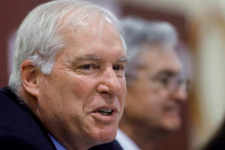 In this Nov. 25, 2019 file photo Federal Reserve Bank of Boston President Eric Rosengren, left, speaks during a round table discussion at Silver Lane Elementary School, in East Hartford, Conn. Rosengren said in remarks delivered online Wednesday, Aug. 12, 2020, that states in the South and West that allowed their businesses to reopen after short shutdowns saw an initial burst of economic activity. But spikes in infection rates soon followed and those states’ economies are now lagging those in the Northeast as consumers have become more cautious.
