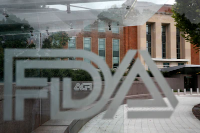 This Aug. 2, 2018, file photo shows the U.S. Food and Drug Administration building behind FDA logos at a bus stop on the agency's campus in Silver Spring, MD.