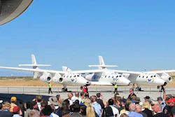 A crowd gathers outside Spaceport America for a dedication ceremony.