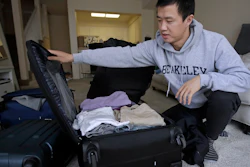 In this Feb. 4, 2019, photo, Leo Wang packs a suitcase at his home in San Jose, Calif. Wang has found himself trapped in an obstacle course regarding H-1B work visas for foreigners. His visa denied and his days in the United States numbered, A federal judge on Thursday, Oct. 1, 2020, temporarily lifted a visa ban on a large number of work permits, undercutting a measure that the Trump administration says will protect American jobs in a pandemic-wracked economy.