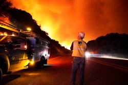 A Pacific Gas and Electric worker looks up at the advancing Creek Fire along Highway 168 near Alder Springs, Calif., Sept. 8, 2020.