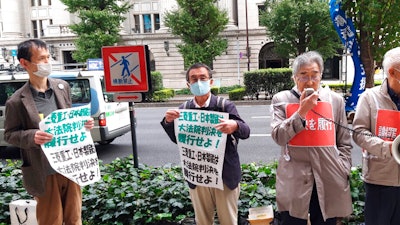 Members of Japanese civil groups attend a rally near Mitsubishi Heavy Industries headquarters in Tokyo, Japan.