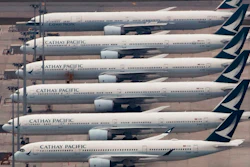 In this March 6, 2020, file photo, Cathay Pacific Airways aircrafts line up on the tarmac at the Hong Kong International Airport. Hong Kong airline Cathay Pacific Airways on Wednesday, Oct. 21, 2020, said it would cut 8,500 jobs and shut down its regional airline unit in a corporate restructuring, as it grapples with the plunge in air travel due to the pandemic.