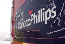 This Feb. 9, 2016, file photo shows an ice-covered ConocoPhillips sign at a drilling site in Nuiqsut, Alaska. ConocoPhillips is buying shale producer Concho Resources in an all-stock deal valued at $9.7 billion. The companies said Monday, Oct. 19, 2020, that the combined business will be the largest independent oil and gas company, with pro forma production of more than 1.5 million barrels of oil equivalent per day.