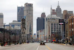 In this March 24, 2020 file photo, Woodward Avenue is shown nearly empty in Detroit. Before the coronavirus showed up, downtown Detroit was returning to its roots as a vibrant city center, motoring away from its past as the model of urban ruin. Now, with the coronavirus forcing many office workers to their homes in the suburbs, those who remain wonder if revitalization will ever return.