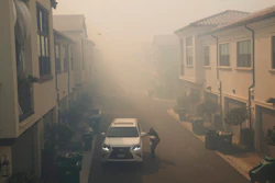 A man leaves his home during a mandatory fire evacuate as smoke from the Silverado Fire fills the air, Monday, Oct. 26, 2020, in Irvine, Calif.
