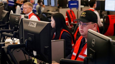 In this Oct. 10, 2019, file photo, Pacific Gas & Electric employees work in the PG&E Emergency Operations Center in San Francisco. When Pacific Gas & Electric set up emergency operations centers to coordinate intentional blackouts intended to prevent wildfires in Northern California, the nation's largest utility forgot one thing, emergency managers who knew the fundamentals of emergency management in California.