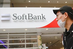 People walk by a SoftBank shop in Tokyo, Monday, Nov. 9, 2020.
