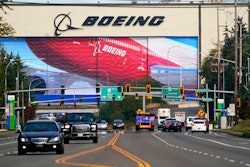 Traffic passes the Boeing airplane production plant, in Everett, Wash.