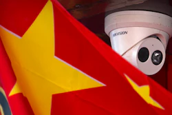 A Chinese flag hangs near a Hikvision security camera outside of a shop in Beijing on Oct. 8, 2019.