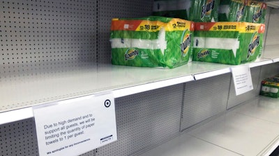 Sign limiting the quantity of paper towels customers can buy at a Target store in Bloomington, Minn., Nov. 17, 2020.