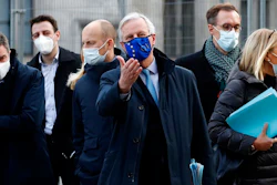 In this file photo dated Thursday, Nov. 12, 2020, European Commission's Head of Task Force for Relations with the United Kingdom Michel Barnier, centre, leaves the Conference Centre in London with unidentified members of his team. The Brexit trade negotiations have been suspended Thursday Nov. 19, 2020, at a crucial stage because an EU negotiator has tested positive for the coronavirus and EU chief negotiator Michel Barnier said that “we have decided to suspend the negotiations at our level for a short period.”