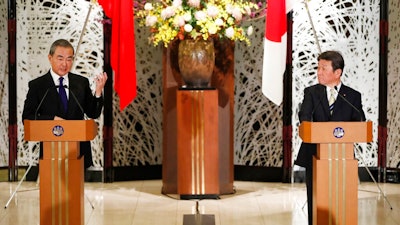 China' Foreign Minister Wang Yi, left, and his Japanese counterpart Toshimitsu Motegi participate in a press briefing in Tokyo on Tuesday, Nov. 24, 2020. Wang met Motegi on Tuesday to discuss ways to revive their pandemic-hit economies as well as regional concerns over China’s growing influence.