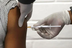 In this Wednesday, June 24, 2020 file photo, a volunteer receives an injection at the Chris Hani Baragwanath hospital in Soweto, Johannesburg, as part of Africa's first participation in a COVID-19 vaccine trial developed at the University of Oxford in Britain in conjunction with the pharmaceutical company AstraZeneca. On Friday, Oct. 23, 2020, AstraZeneca Inc. announced that the Food and Drug Administration is letting it resume testing of its COVID-19 vaccine candidate in the U.S.