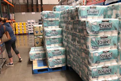 A shopper loads her basket next to a display of paper towels in a Costco warehouse in this photograph taken on Nov. 18 in Sheridan, CO.