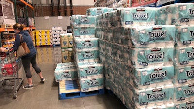 A shopper loads her basket next to a display of paper towels in a Costco warehouse in this photograph taken on Nov. 18 in Sheridan, CO.