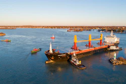 Tugboats work to free the freighter Harvest Spirit that turned sideways and grounded in the Livingstone Channel of the Detroit River.