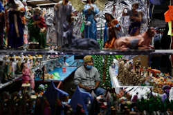 A vendor sells nativity figurines, in a Christmas market where organizers were still deciding if they would close at 5 p.m., in accordance with a new state mandate intended to help slow the spread of COVID-19, in Ecatepec, Mexico State, on the outskirts of Mexico City on Dec. 14.