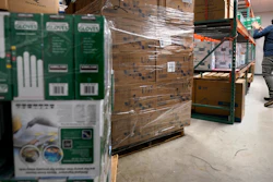 Ray Bellia stocks shelves with personal protective gloves, used by medical and law enforcement professionals, while unpacking pallets of other PPE goods in the warehouse of his Body Armor Outlet store on Dec. 9 in Salem, NH.