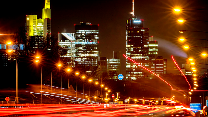 Long time exposure photo shows commuters driving towards Frankfurt, Germany, Thursday, Jan. 14, 2021. In background the buildings of the banking district.