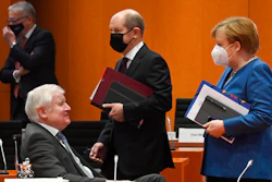 Chancellor Angela Merkel walks beside Finance Minister Olaf Scholz and Interior Minister Horst Seehofer prior to a cabinet meeting, Jan. 6, 2021, the Chancellery, Berlin.