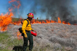 In this June 11, 2020 file photo Wynn Whitmeyer of the Idaho Falls Fire Department uses a drip can to ignite cheat grass and tumbleweeds during a controlled burn east of Idaho Falls, Idaho. Environmentalists have filed a notice of intent to sue the U.S government to block plans to build up to 11,000 miles (17,700 kilometers) of fuel breaks they claim would violate the Endangered Species Act in a misguided effort to slow the advance of wildfires in six Western states.