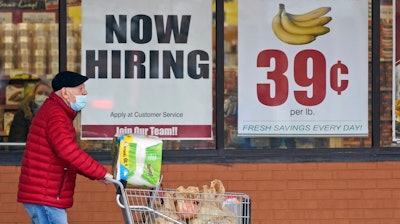 A man walks out of a Marc's Store, Friday, Jan. 8, 2021, in Mayfield Heights, Ohio. Fewer Americans applied for unemployment benefits last week, lowering claims to 900,000, still a historically high level that points to further job cuts in a raging pandemic.