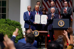 In this June 5, 2020 file photo, President Donald Trump poses for a photo after signing the Paycheck Protection Program Flexibility Act during a news conference in the Rose Garden of the White House in Washington. Thousands of minority-owned small businesses were at the end of the line in the government’s coronavirus relief program as many struggled to find banks to accept their applications. Or, they were disadvantaged by the program's terms. Data from the Paycheck Protection Program analyzed by The Associated Press show many minority owners desperate for a loan didn’t receive one until the PPP's last weeks.