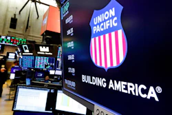 In this Sept. 13, 2019, file photo the logo for Union Pacific appears above a trading post on the floor of the New York Stock Exchange. Union Pacific’s fourth quarter profit chugged ahead as shipping volume improved for the first time since before the coronavirus pandemic slowed the economy to a crawl last year. The Omaha, Nebraska-based railroad said Thursday, Jan. 21, 2021, that it earned $1.38 billion, or $2.05 per share, in the quarter, but the results were weighed down by a one-time charge of $278 million.