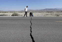 Ron Mikulaco, right, and his nephew, Brad Fernandez, examine a crack caused by an earthquake on Highway 178 outside of Ridgecrest, Calif., July 6, 2019.