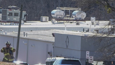 A Hall County firefighter leaves following a liquid nitrogen leak that killed six people at Prime Pak Foods, a poultry plant, on Jan. 28 in Gainesville, GA.