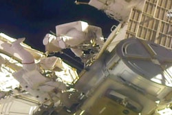 Astronauts Mike Hopkins, left, and Victor Glover work outside the International Space Station, Feb. 1, 2021.