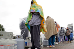 Carlos Mandez waits in line to fill propane tanks, Houston, Feb. 17, 2021.