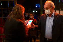 A man presents his 'green passport,' proof that he is vaccinated against the coronavirus, at the Khan Theater in Jerusalem, Feb. 23, 2021.