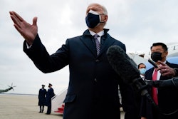 President Joe Biden speaks to member of the media after exiting Air Force One, Friday, Feb. 19, 2021, in Andrews Air Force Base, Md.