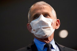 In this Dec. 22, 2020, file photo, Dr. Anthony Fauci, director of the National Institute of Allergy and Infectious Diseases, speaks before receiving his first dose of the COVID-19 vaccine at the National Institutes of Health, in Bethesda, Md. Fauci suggests fans enjoy the Super Bowl on Sunday, Feb. 7, 2021 with people in their household.
