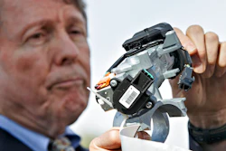 In this April 1, 2014, file photo, Clarence Ditlow, executive director of the Center for Auto Safety, displays a GM ignition switch similar to those linked to 13 deaths and dozens of crashes of General Motors small cars like the Chevy Cobalt, during a news conference on Capitol Hill in Washington. General Motors Co., has agreed to a $5.75 million settlement with California regarding false statements the company made to investors about problems with its deadly ignition switches, state officials announced Friday, Feb. 12, 2021. The faulty ignition switches led to at least 124 fatalities and 274 injuries nationwide.