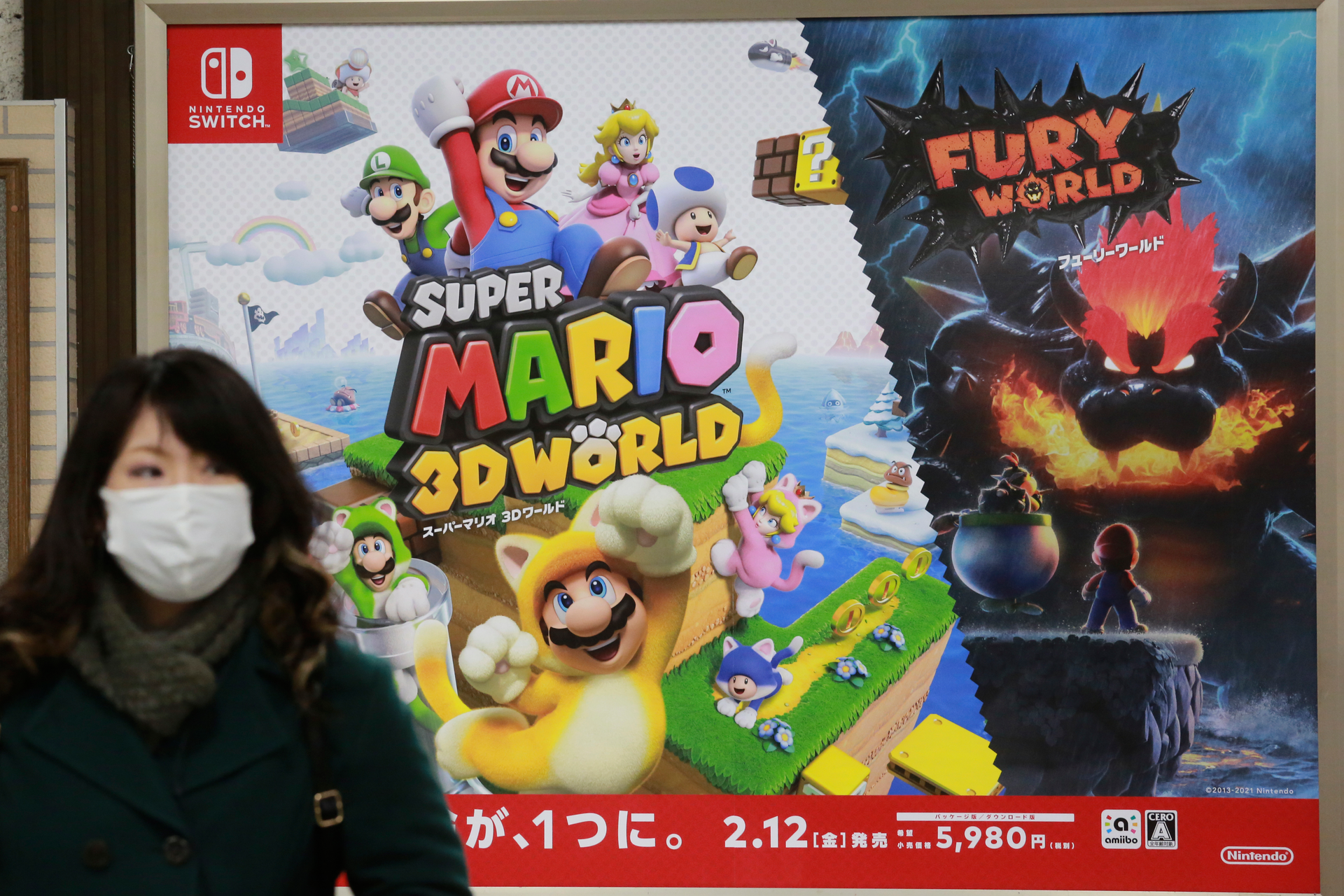 A woman walks by posters of Nintendo in Tokyo. The Japanese video game maker said profit surged to $3.6 billion.